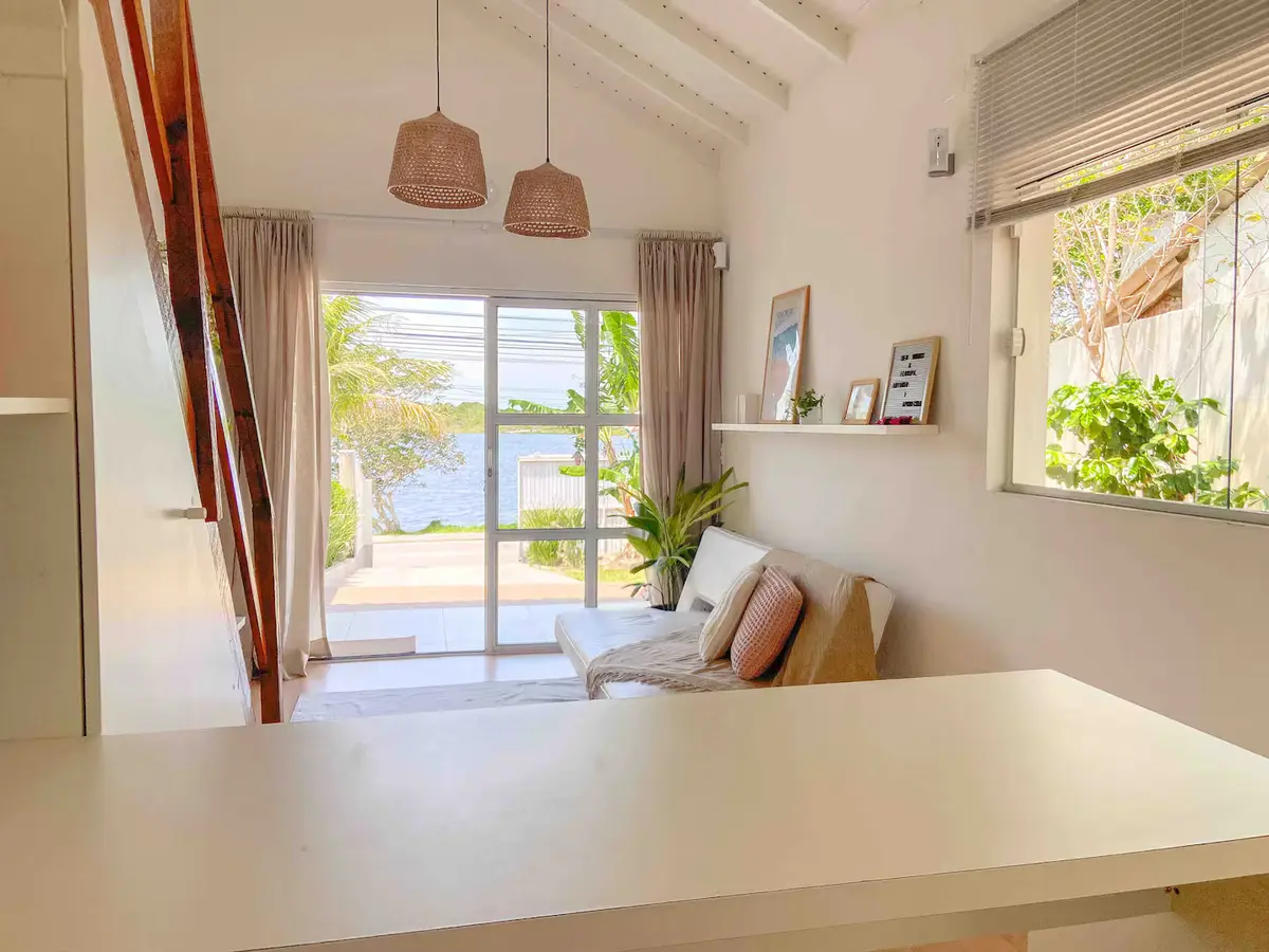 Sala com sofá e vista para a lagoa